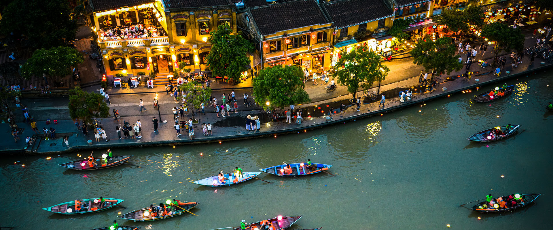 Hoi An’s charming ancient architecture in Vietnam on a Hoi An Travel banner by Legend Travel Group.