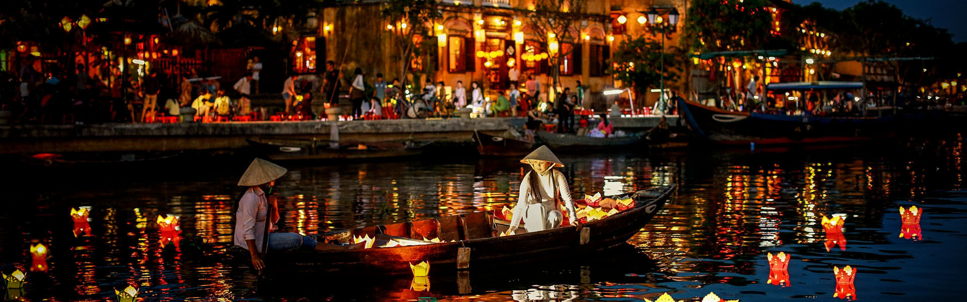 Ancient Hoi An lantern-lit streets in Da Nang on a scenic Hoi An Travel banner by Legend Travel Group.