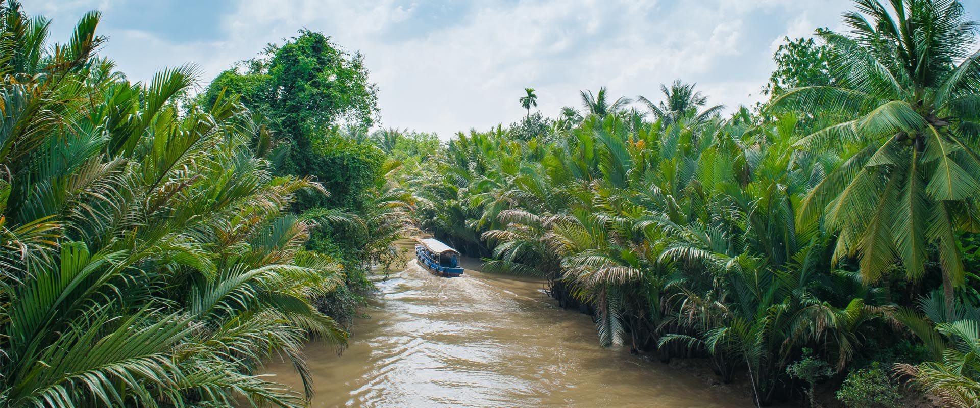Ben Tre’s tranquil delta landscape at dusk on a Ben Tre Travel banner by Legend Travel Group.