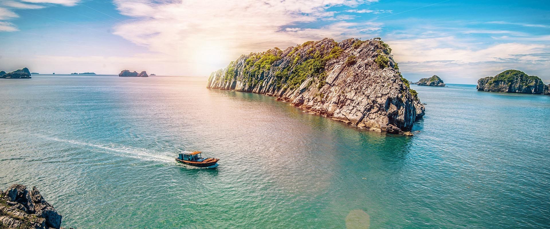 Cat Ba’s lush coastal scenery in Vietnam on a Cat Ba Travel banner by Legend Travel Group.