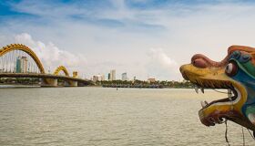 Iconic Da Nang Dragon Bridge for a vibrant Da Nang Tours banner with Legend Travel Group.