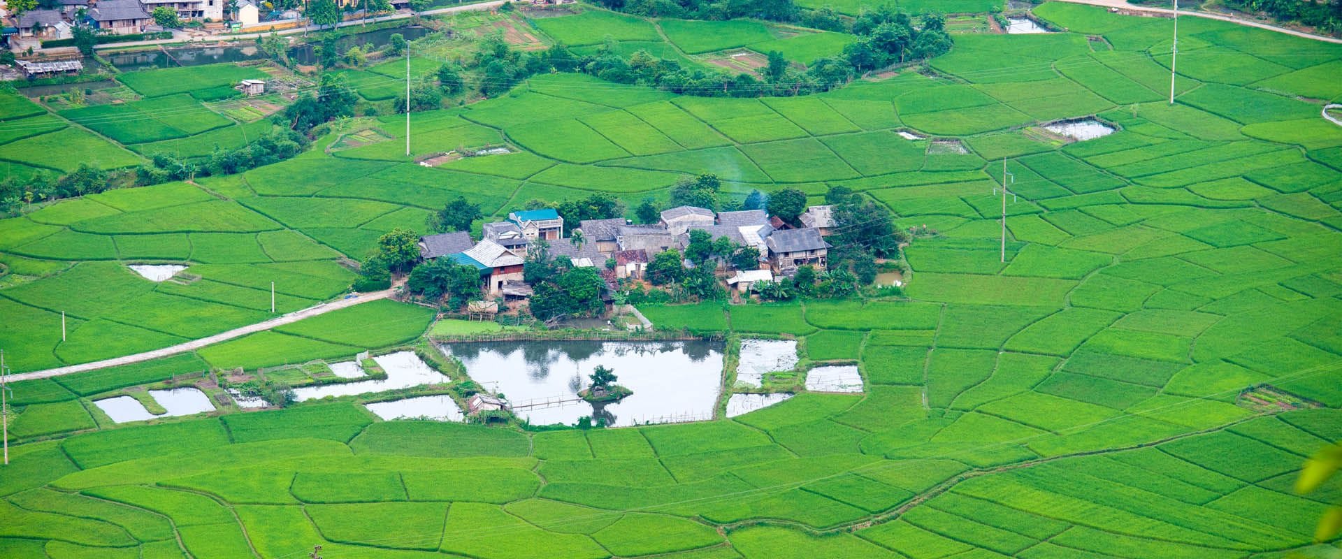 Panoramic view of Mai Chau’s highland scenery for a scenic Mai Chau Travel banner by Legend Travel Group.
