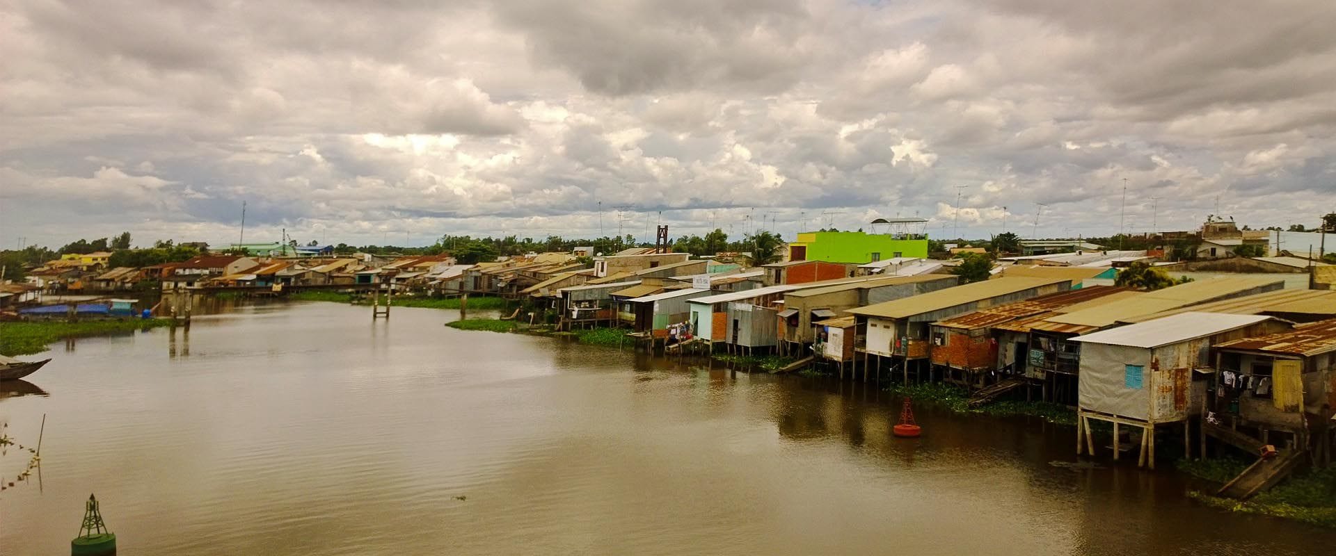 Long An’s tranquil delta fields in Vietnam on a Long An Travel banner by Legend Travel Group.