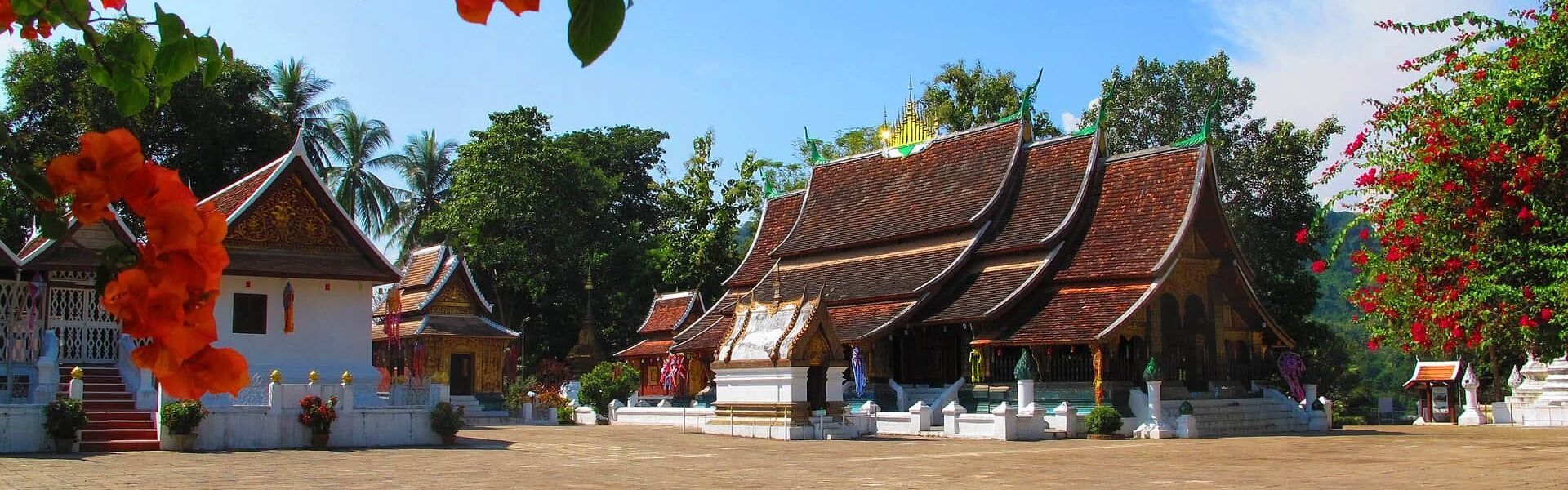 Iconic Laos temple spires for a vibrant Laos Travel banner with Legend Travel Group.