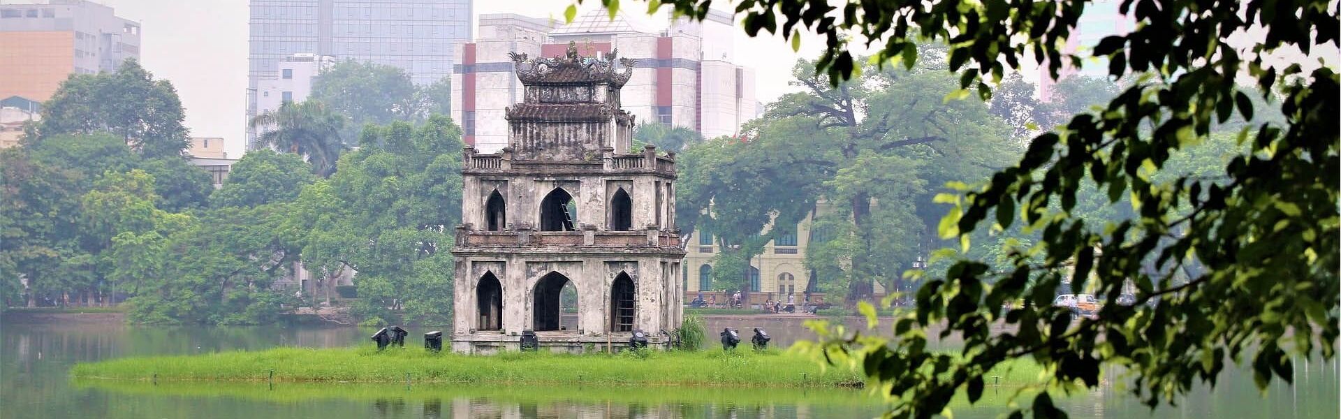Iconic Hanoi Hoan Kiem Lake for a vibrant Hanoi Travel banner with Legend Travel Group.