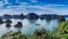 Vibrant Halong Bay seascape at dawn for a Halong Bay Tours banner by Legend Travel Group.