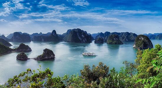 Vibrant Halong Bay seascape at dawn for a Halong Bay Tours banner by Legend Travel Group.
