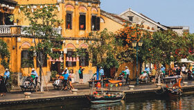 Tranquil Hoi An riverside at dusk for a Hoi An Tours banner by Legend Travel Group.