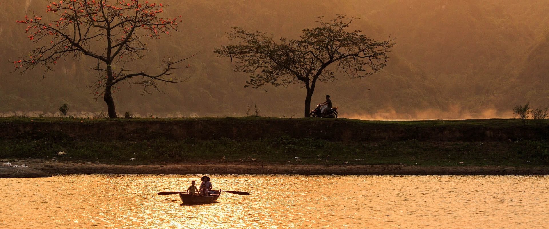 Lush Vietnam Countryside at sunset on a Vietnam Travel banner by Legend Travel Group.