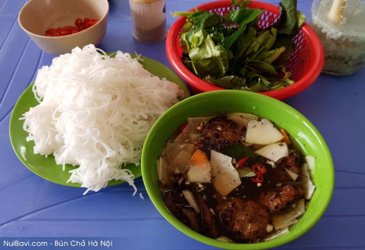 Enjoy Hanoi’s savory dish with fresh herbs and dipping sauce