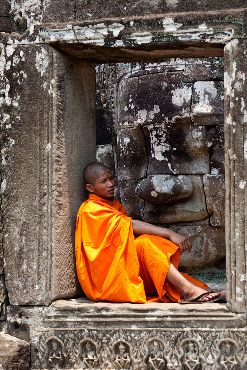 Buddhist Monk sitting at Angkor Thom Temple, Cambodia