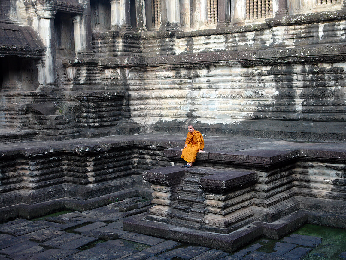 Buddhist Monk sitting in the Temples of Angkor Complex, Cambodia