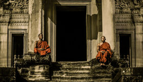 Buddhist Monks sitting and praying at Angkor Wat Temple, Cambodia