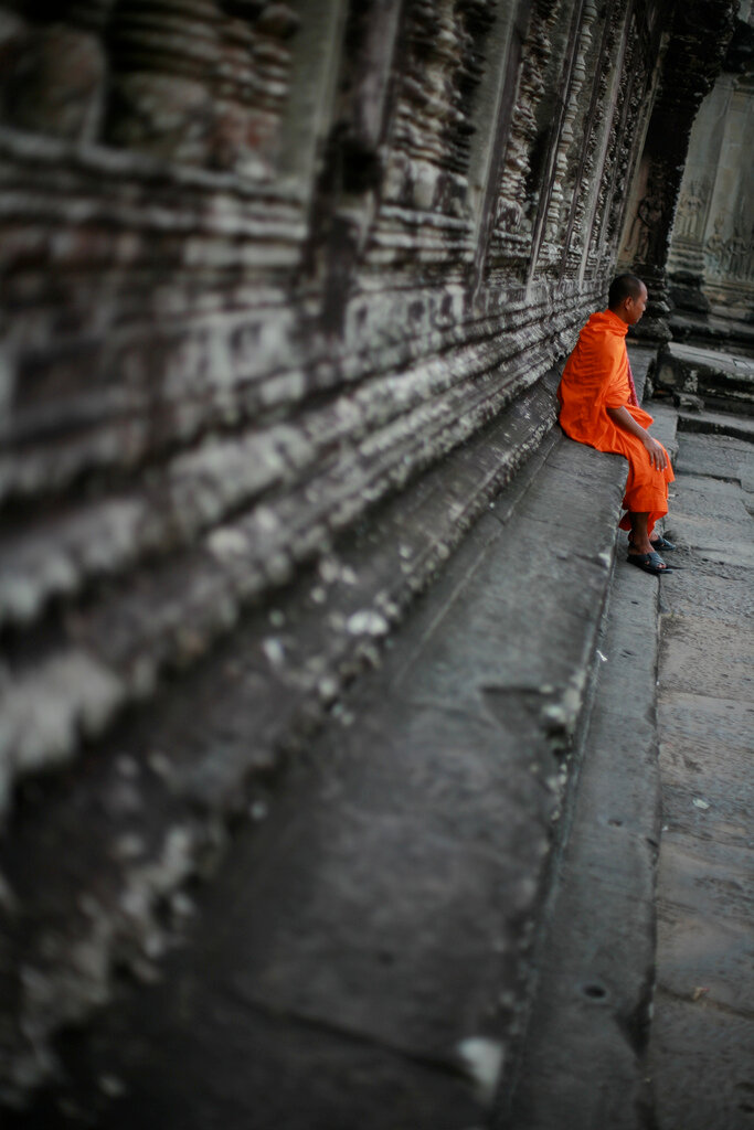 Buddhist Monk sitting at Ancient Temple, Angkor Complex, Cambodia