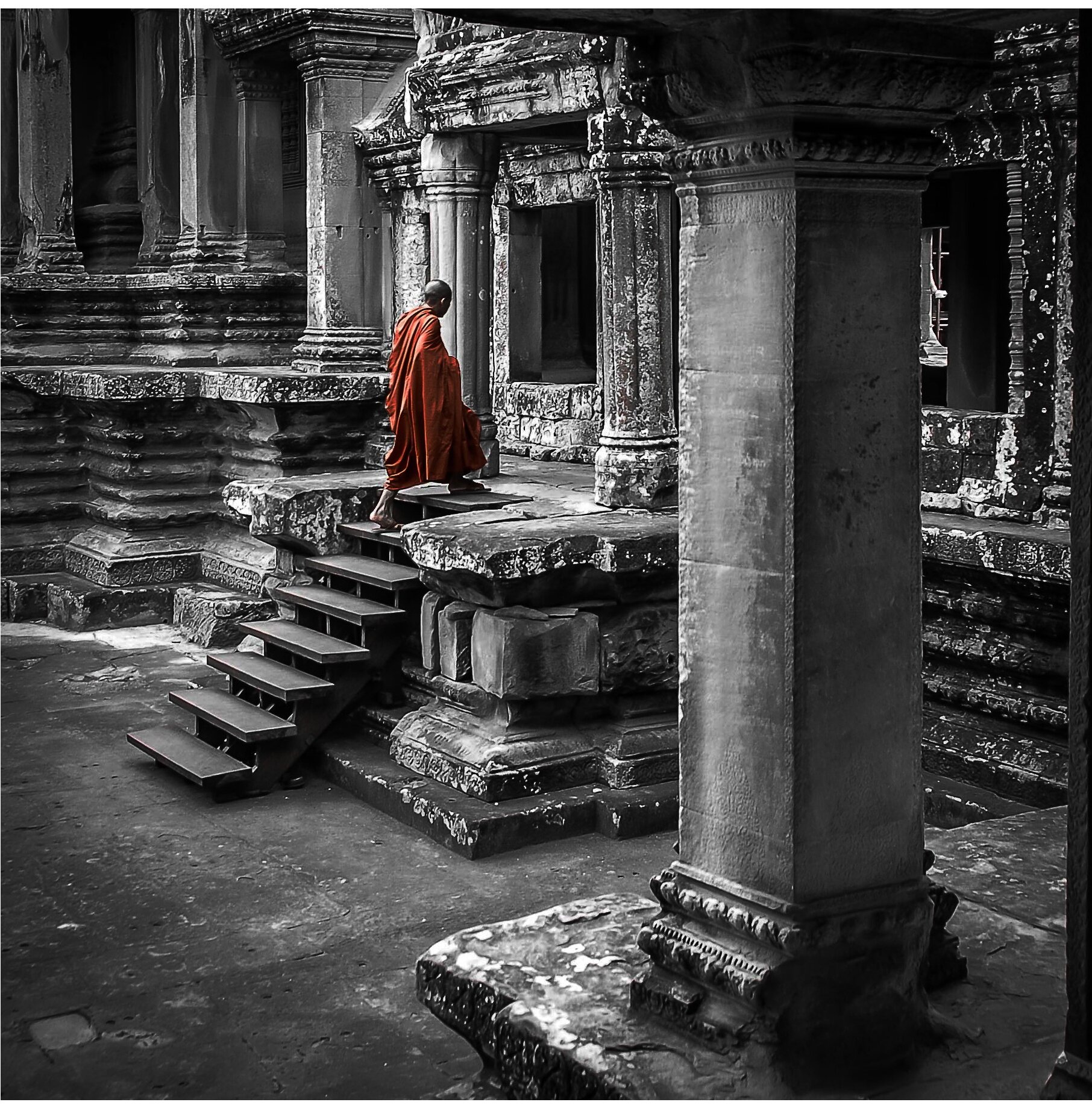 Buddhist Monk walking into the Temple at Angkor Complex, Cambodia