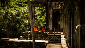 Buddhist Monks sitting in the Angkor Temples, Siem Reap, Cambodia
