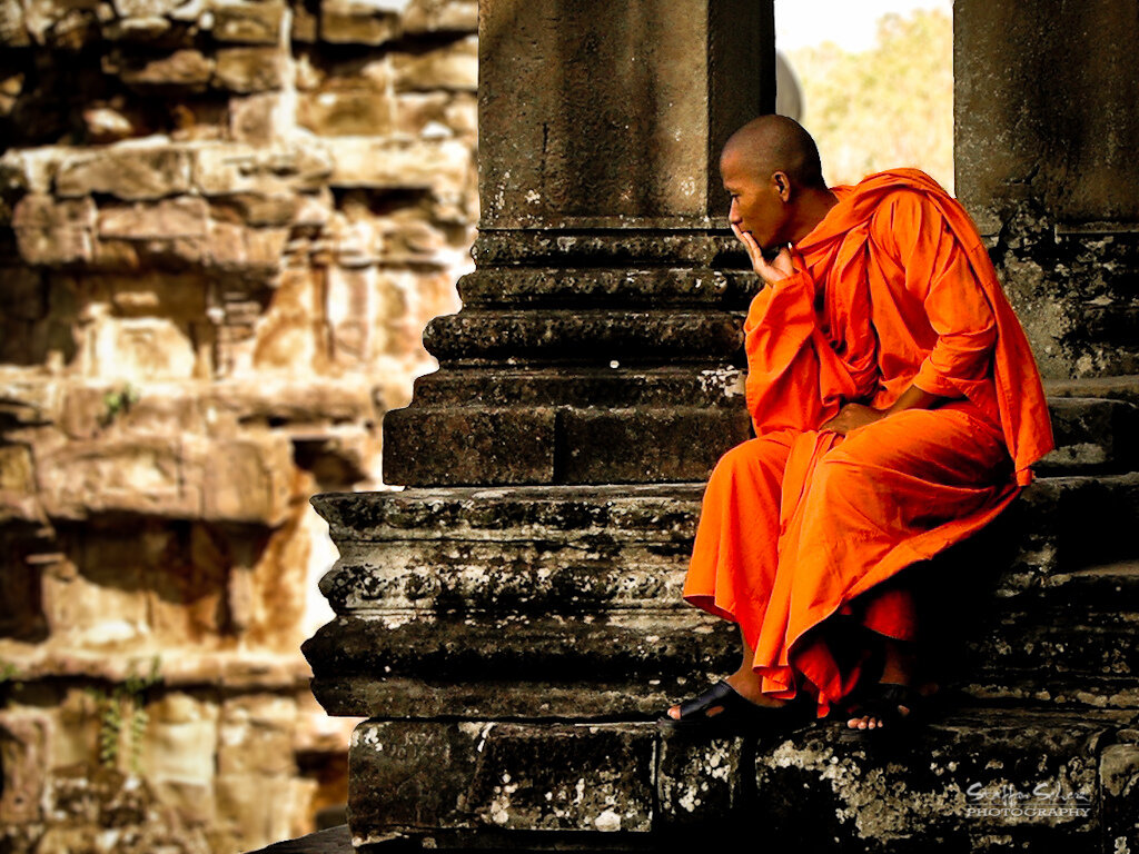 Buddhist Monk sitting at Angkor Temple, Siem Reap