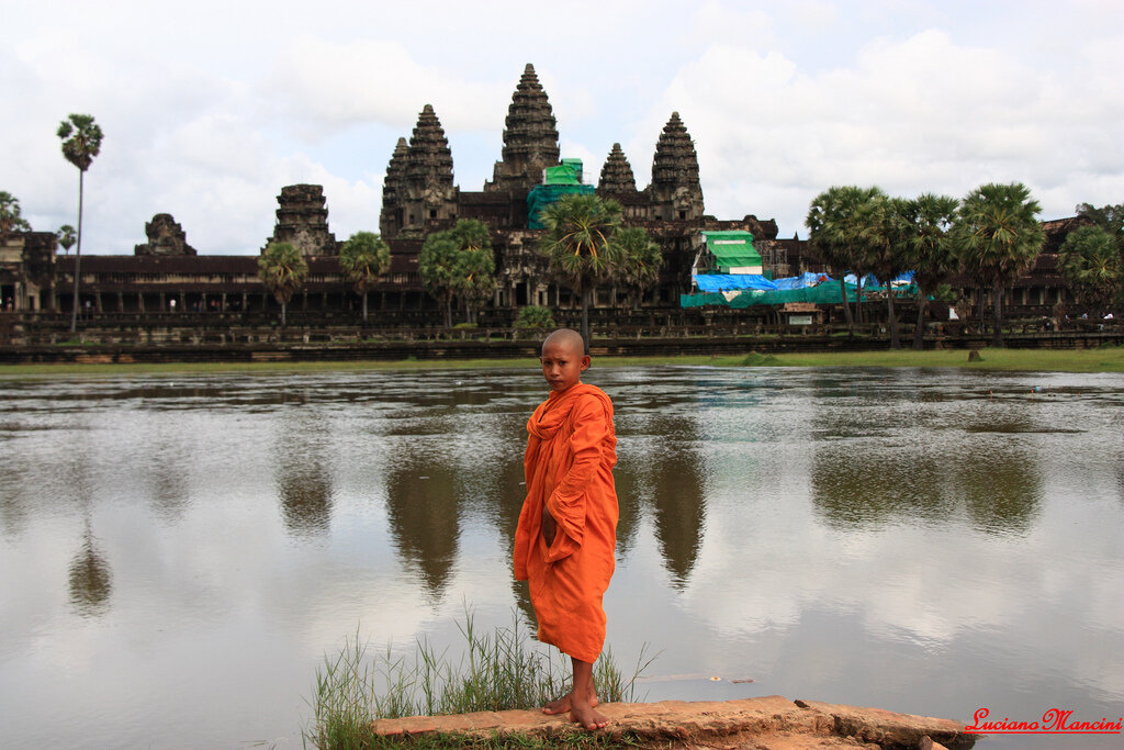 Buddhist Monk standing in front of of Angkor Wat, Siem Reap