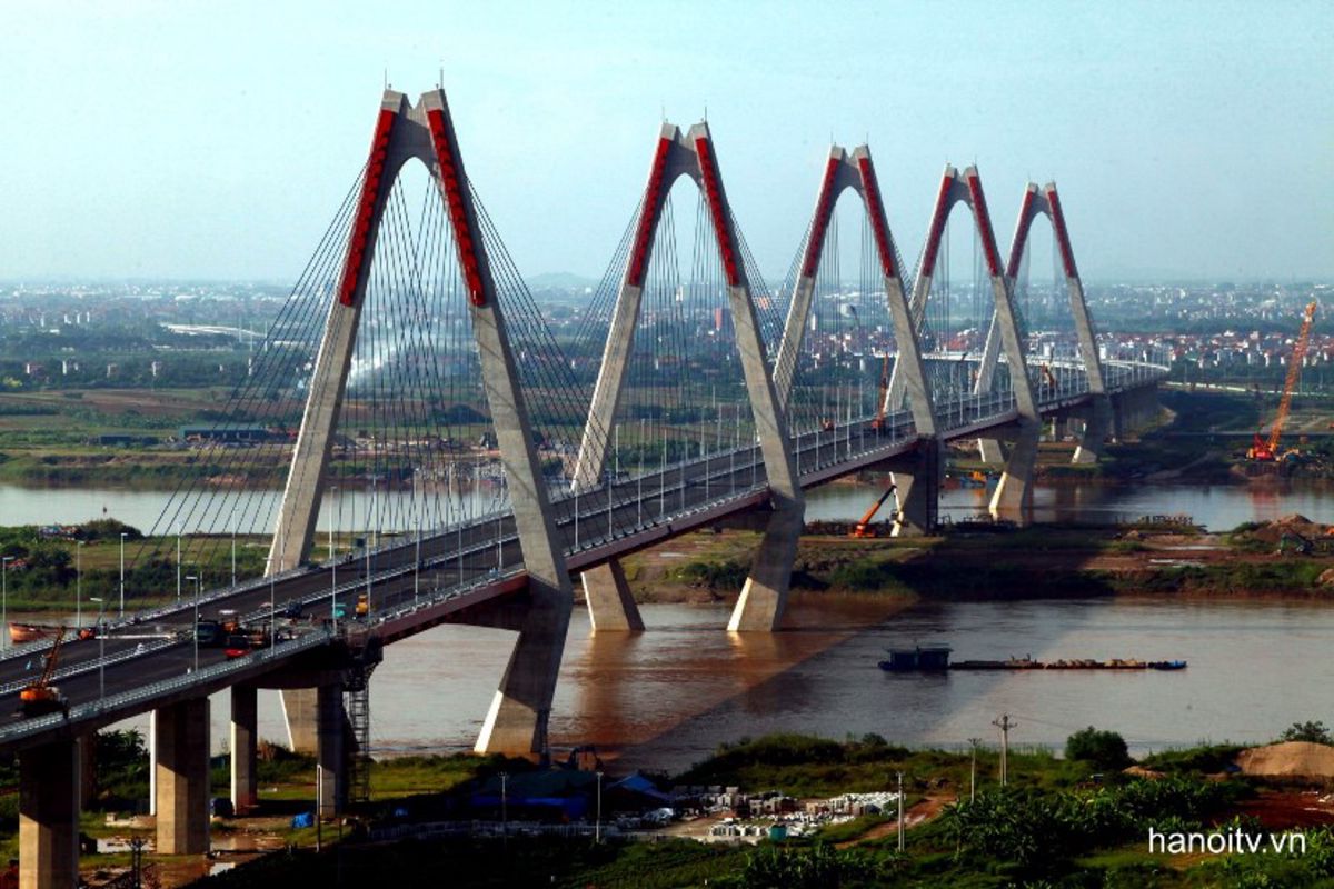 Cross Hanoi’s iconic red bridge for panoramic river views